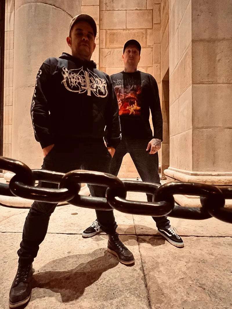 Basti and Marco behind a heavy chain